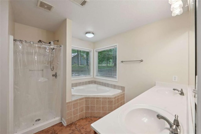 full bath featuring a shower stall, tile patterned flooring, a garden tub, and double vanity
