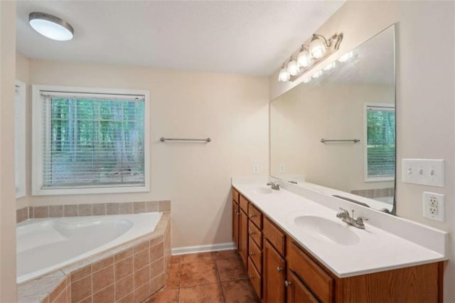 bathroom featuring double vanity, a garden tub, tile patterned flooring, and baseboards