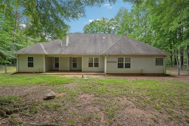 rear view of property with a patio and a chimney