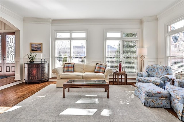 620 Elizabeth Oak Ct, Alpharetta, GA 30004 - living area featuring arched walkways, wood finished floors, ornamental molding, a decorative wall, and a wainscoted wall