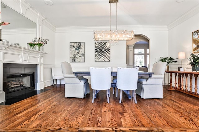 620 Elizabeth Oak Ct, Alpharetta, GA 30004 - dining space with arched walkways, dark wood-style flooring, a fireplace with flush hearth, and ornamental molding