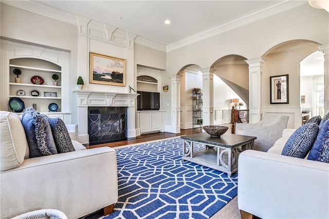 620 Elizabeth Oak Ct, Alpharetta, GA 30004 - living room with built in features, decorative columns, ornamental molding, wood finished floors, and a wainscoted wall