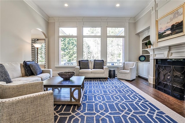 620 Elizabeth Oak Ct, Alpharetta, GA 30004 - living area featuring crown molding, dark wood finished floors, arched walkways, recessed lighting, and built in shelves