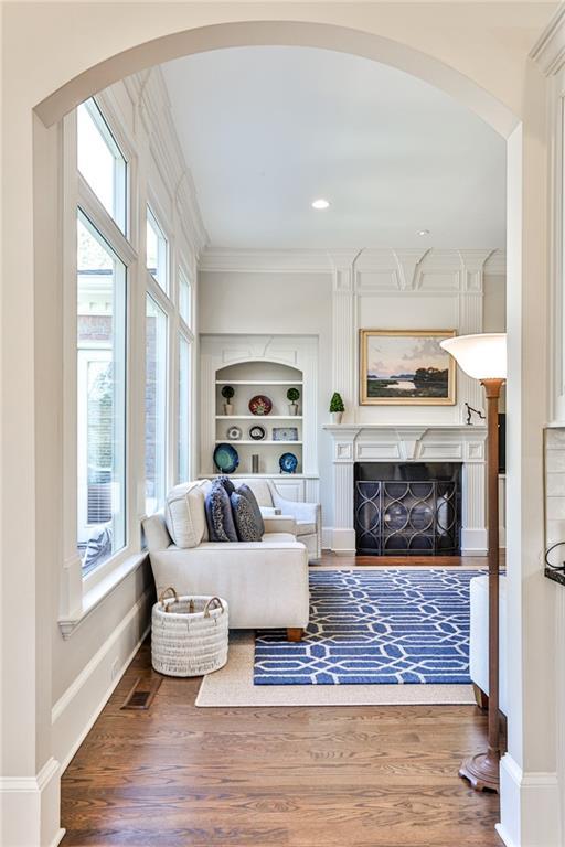 620 Elizabeth Oak Ct, Alpharetta, GA 30004 - living area with ornamental molding, plenty of natural light, wood finished floors, and arched walkways