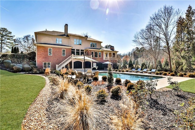 620 Elizabeth Oak Ct, Alpharetta, GA 30004 - rear view of house with a chimney, stairway, a lawn, and an outdoor pool