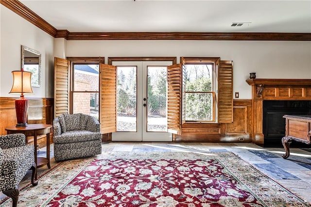 620 Elizabeth Oak Ct, Alpharetta, GA 30004 - living area featuring french doors, ornamental molding, a wainscoted wall, a fireplace with flush hearth, and stone finish floors
