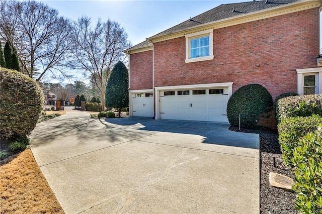 620 Elizabeth Oak Ct, Alpharetta, GA 30004 - view of home's exterior featuring an attached garage, driveway, brick siding, and roof with shingles