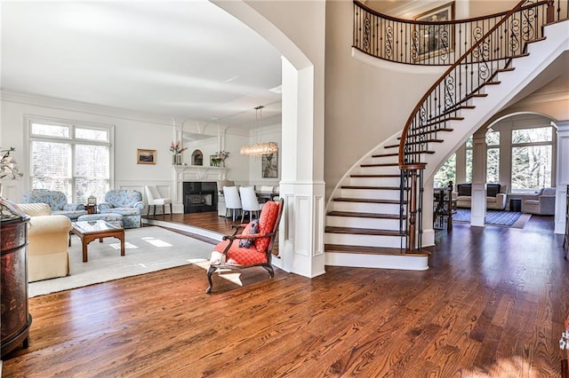 620 Elizabeth Oak Ct, Alpharetta, GA 30004 - living room featuring ornate columns, arched walkways, healthy amount of natural light, crown molding, and a decorative wall