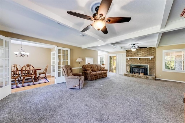 living room with beam ceiling, french doors, wood-type flooring, a fireplace, and ceiling fan with notable chandelier