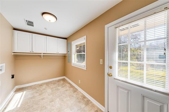 washroom featuring electric dryer hookup, cabinets, a healthy amount of sunlight, and washer hookup