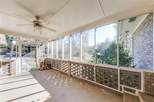 unfurnished sunroom with ceiling fan