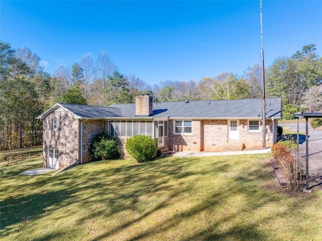 rear view of property with a lawn and a sunroom