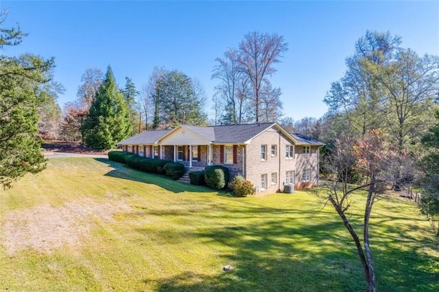 view of side of property featuring covered porch and a yard