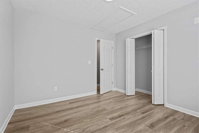 unfurnished bedroom featuring light hardwood / wood-style floors and a closet