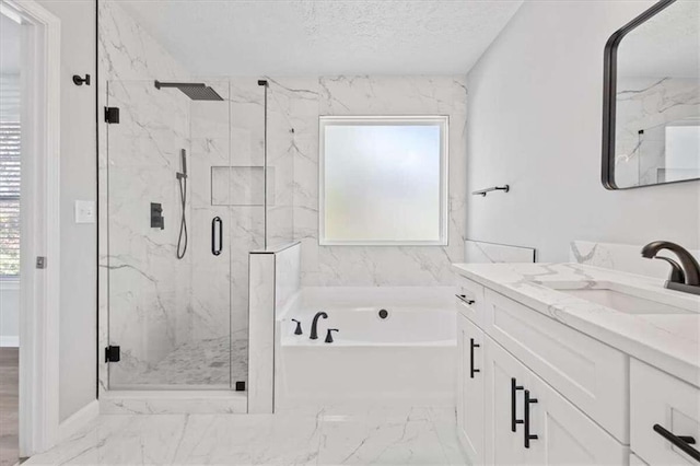 bathroom with plus walk in shower, a textured ceiling, vanity, and a healthy amount of sunlight