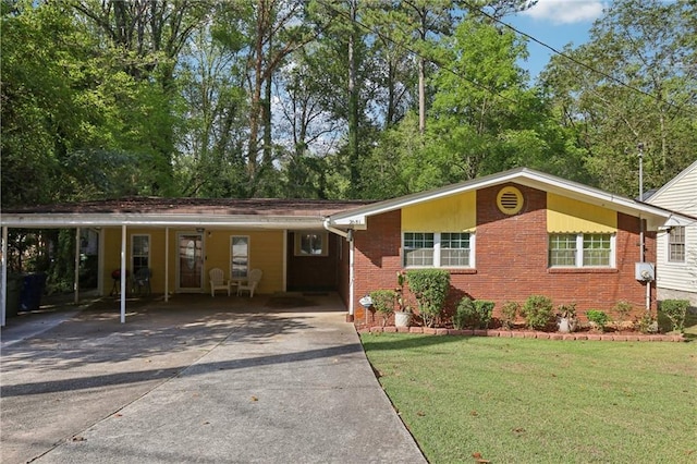 view of front of house with a front lawn, an attached carport, concrete driveway, and brick siding