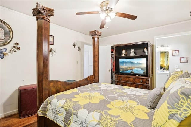 bedroom featuring crown molding, decorative columns, a closet, a ceiling fan, and wood finished floors