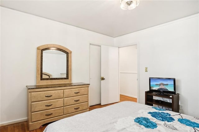 bedroom featuring wood finished floors and baseboards