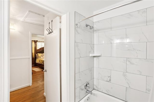 bathroom featuring shower / bathtub combination and wood finished floors