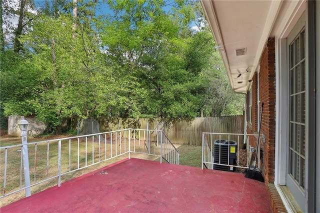 view of patio / terrace with a fenced backyard, visible vents, and central air condition unit