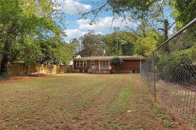 exterior space featuring covered porch, a fenced backyard, and a front lawn