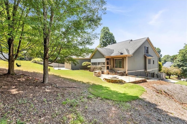 back of house featuring a lawn, entry steps, and a patio area