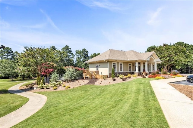 rear view of property with stone siding, stucco siding, and a lawn