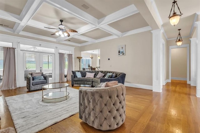 living room with ornate columns, baseboards, ceiling fan, light wood-style floors, and coffered ceiling
