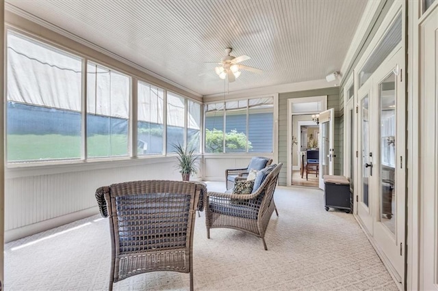 sunroom / solarium featuring a ceiling fan
