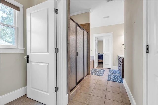 corridor with baseboards and light tile patterned floors