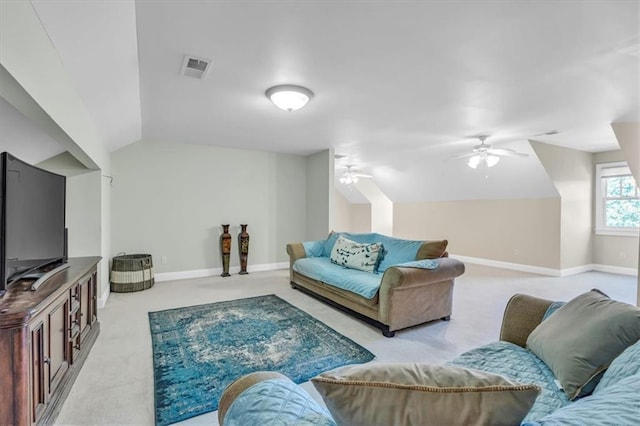 carpeted living area with baseboards, lofted ceiling, visible vents, and a ceiling fan