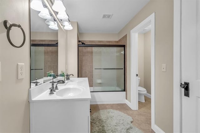 bathroom featuring visible vents, a sink, toilet, and tile patterned floors