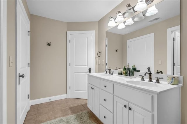 bathroom with visible vents, a sink, tile patterned floors, and double vanity
