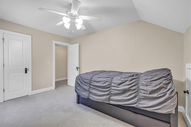 carpeted bedroom featuring a ceiling fan, baseboards, and vaulted ceiling