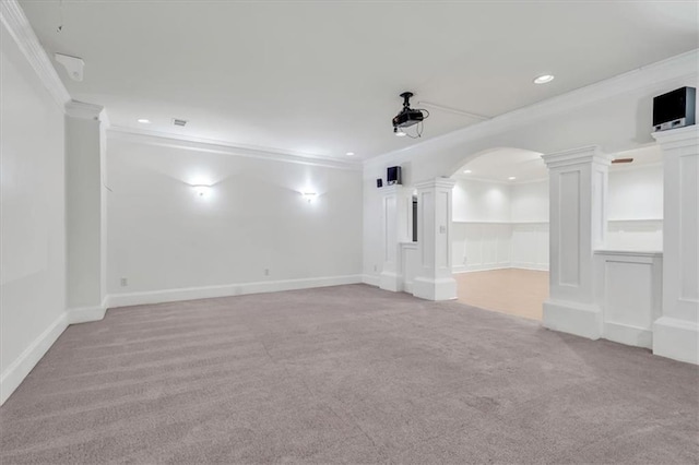 spare room featuring light colored carpet, decorative columns, recessed lighting, and ornamental molding