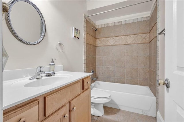 bathroom featuring toilet, vanity, tile patterned flooring, and bathing tub / shower combination