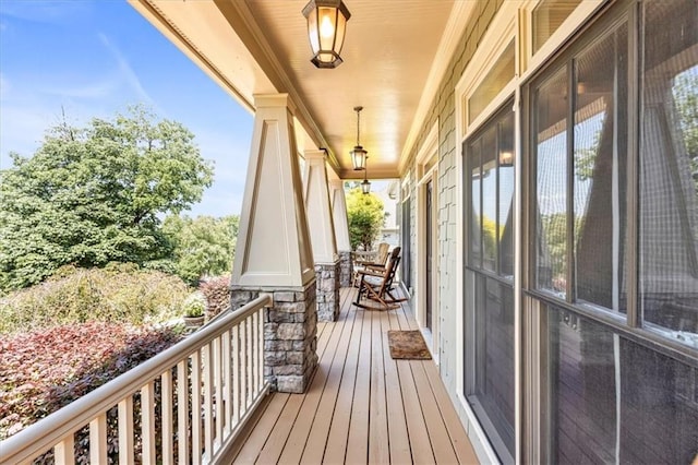 wooden terrace featuring covered porch