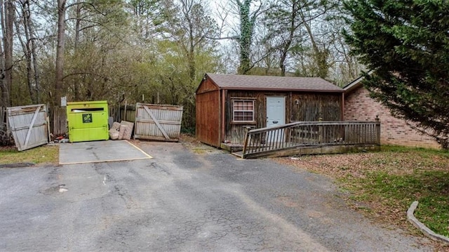 exterior space with an outbuilding and a gate