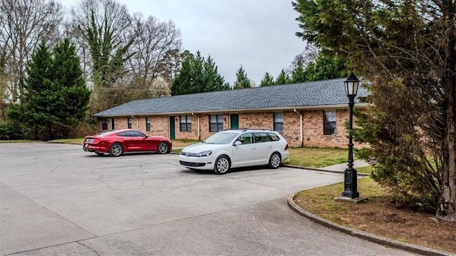 ranch-style house with brick siding and uncovered parking