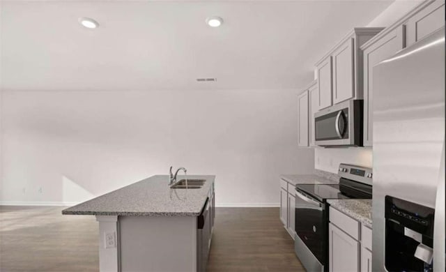 11408 Gray Branch Dr, Lawrenceville, GA 30045 - kitchen with appliances with stainless steel finishes, baseboards, a sink, light stone countertops, and dark wood-style flooring