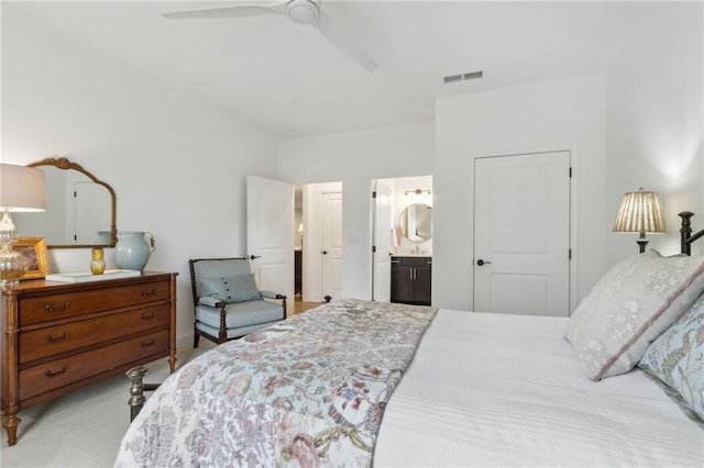 carpeted bedroom with ceiling fan and ensuite bath