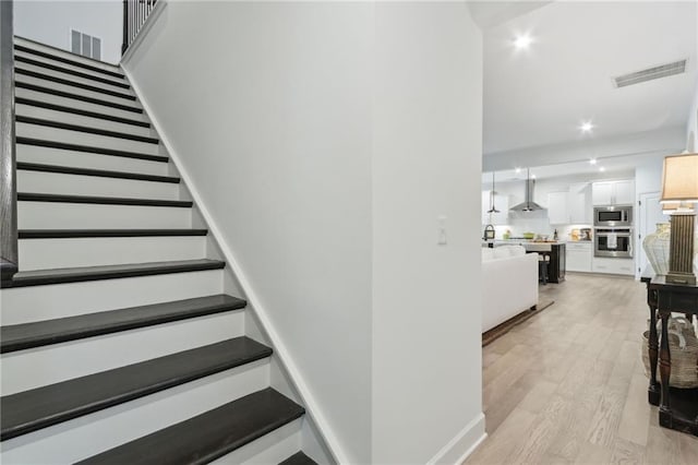 stairs with hardwood / wood-style flooring