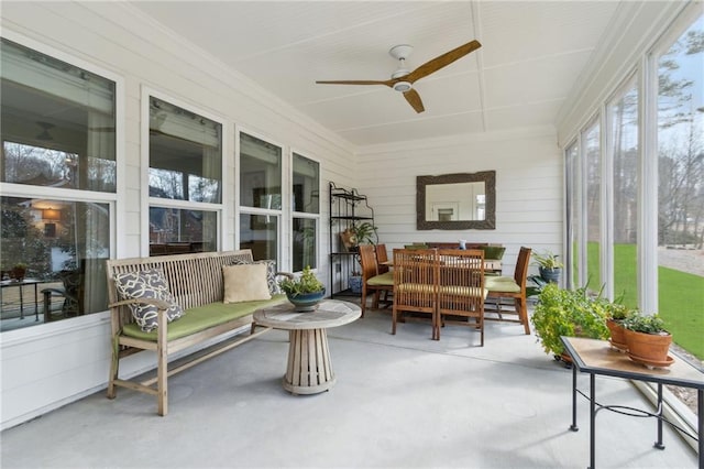 sunroom featuring ceiling fan