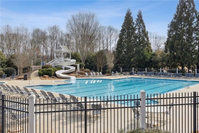 view of swimming pool with a patio and a water slide