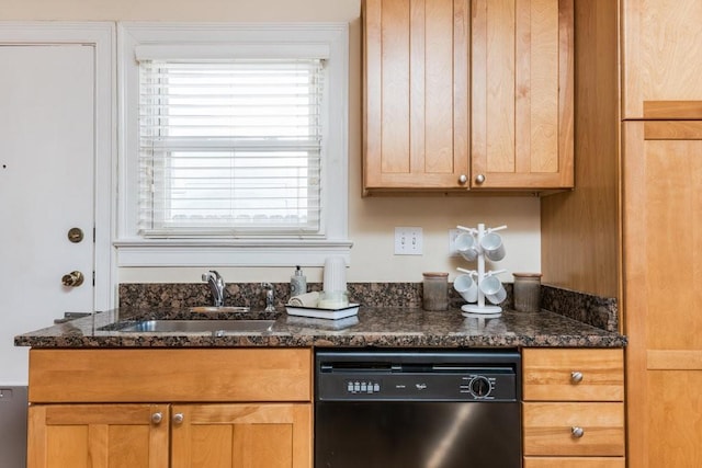 kitchen with black dishwasher, dark stone countertops, and a sink