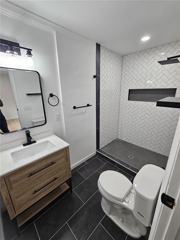 775 Lee Andrews Ave SE, Atlanta, GA 30315 - bathroom with toilet, tiled shower, tile patterned floors, vanity, and recessed lighting