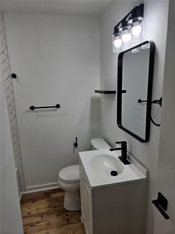 775 Lee Andrews Ave SE, Atlanta, GA 30315 - bathroom with wood finished floors, toilet, and vanity