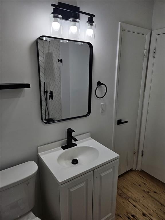 775 Lee Andrews Ave SE, Atlanta, GA 30315 - bathroom with wood finished floors, vanity, and toilet