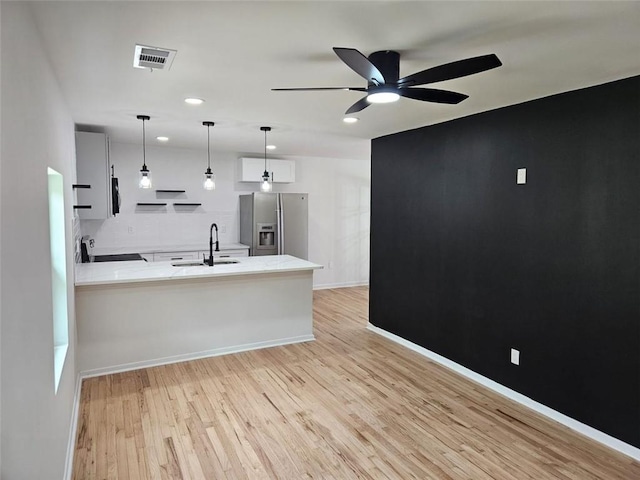 775 Lee Andrews Ave SE, Atlanta, GA 30315 - kitchen featuring stainless steel fridge, a sink, light countertops, a ceiling fan, and light wood-style floors