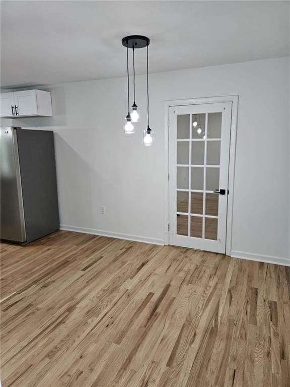 775 Lee Andrews Ave SE, Atlanta, GA 30315 - unfurnished dining area with light wood finished floors and baseboards